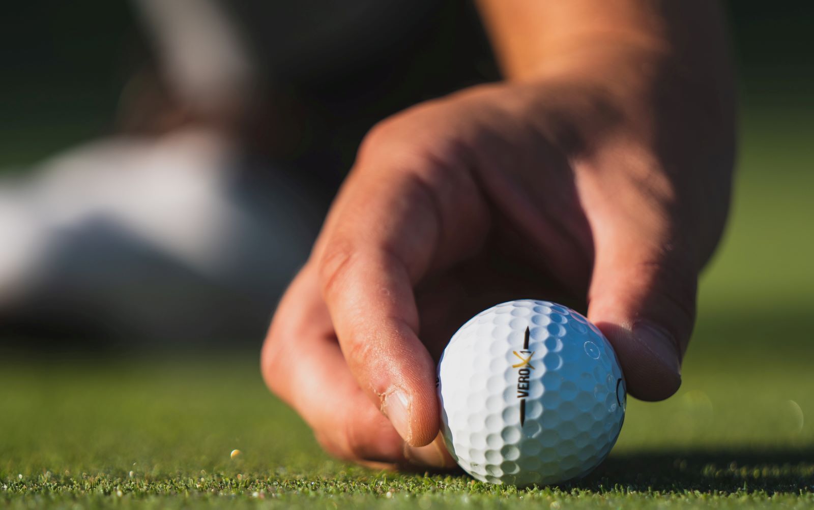 close-up shot of man holding a golf ball