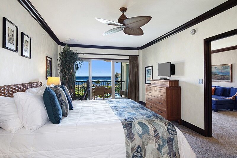 interior of kauai hawaii vacation rental, showcasing a fully furnished bedroom with a stunning view